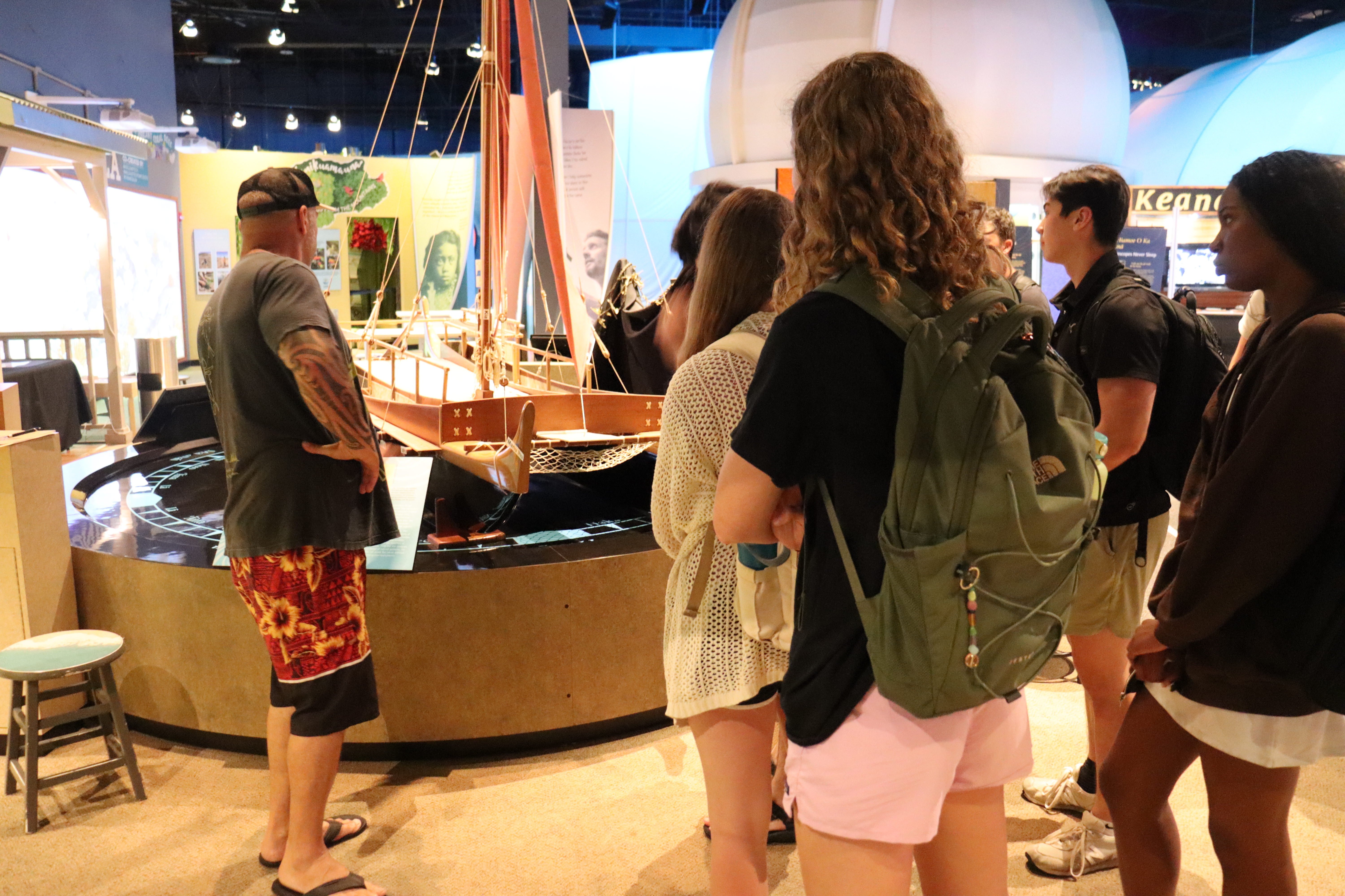 Nick Mar, a titled navigator from New Zealand, explains a canoe exhibit at the ‘Imiloa Astronomy Center.