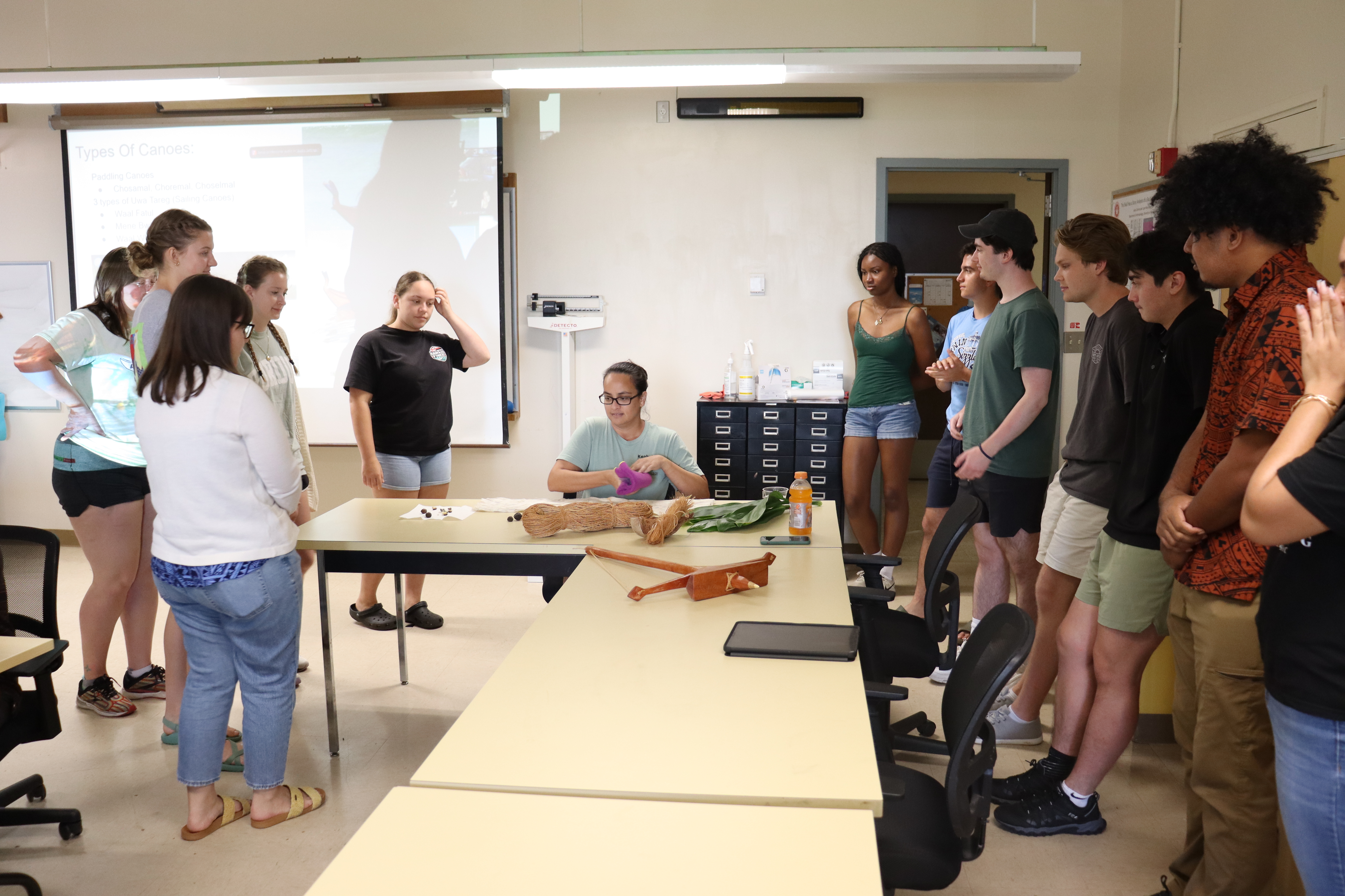 Torri Law, a masters student at UH Hilo, demonstrates how to make a lei from a ti leaf.